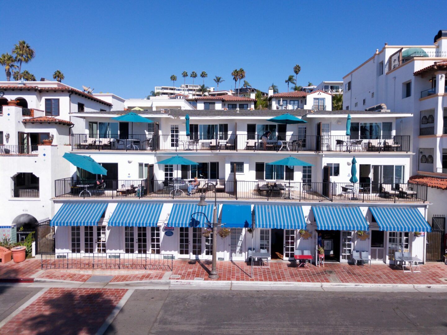 A row of blue and white buildings with awnings.
